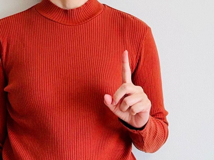 人差し指を立てている女性